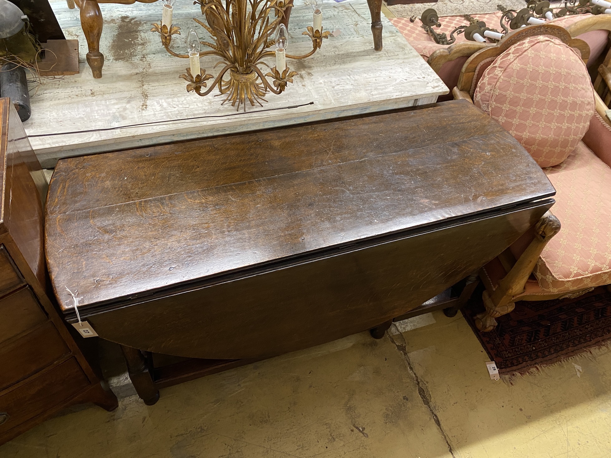 An 18th century oak gateleg table, width 148cm, depth 55cm, height 73cm